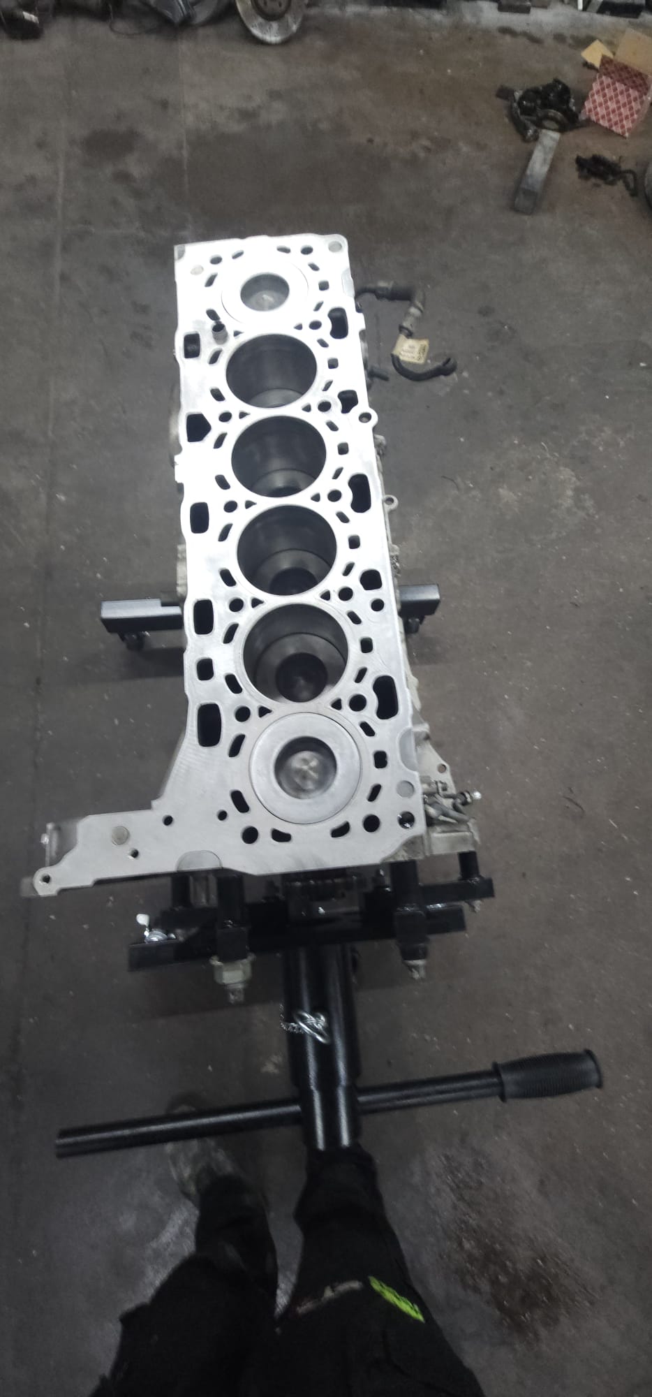 Stripped engine block on a workbench being reconditioned